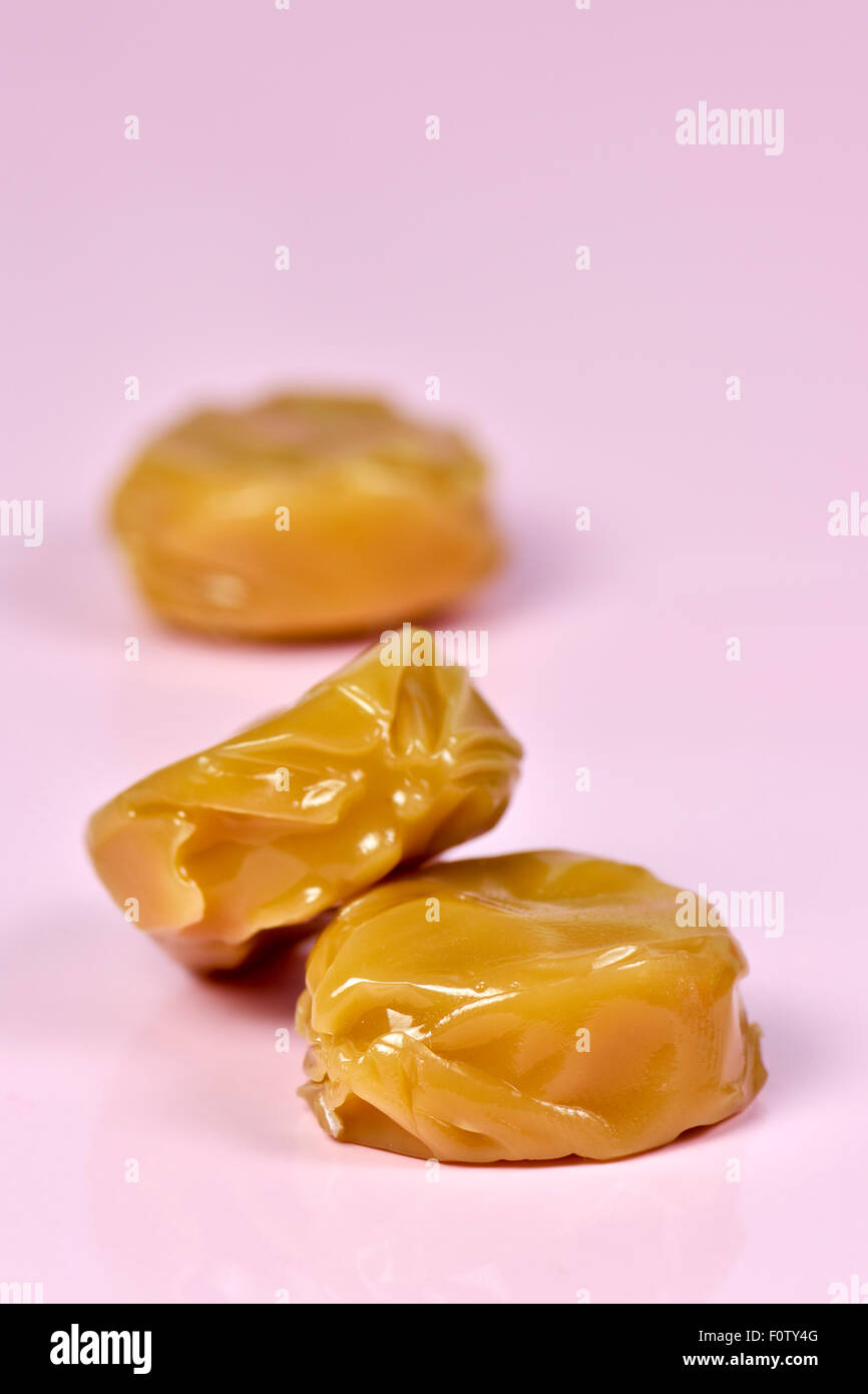 Close up of toffees on pink background Stock Photo