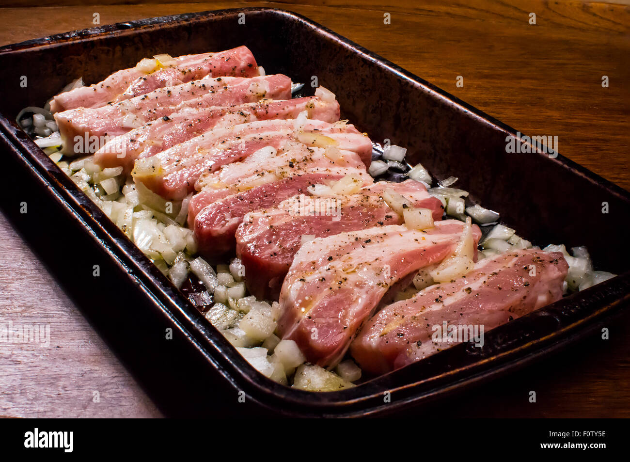 Pork belly slices prepared for baking in the oven Stock Photo