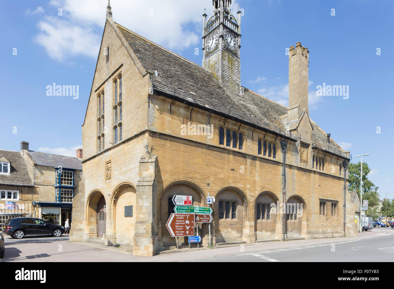 Unattractive road signs against an historic building in Morton in the Marsh, Gloucestershire, England, UK Stock Photo
