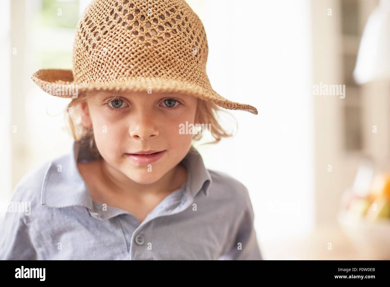 Portrait of boy wearing straw hat, looking at camera Stock Photo