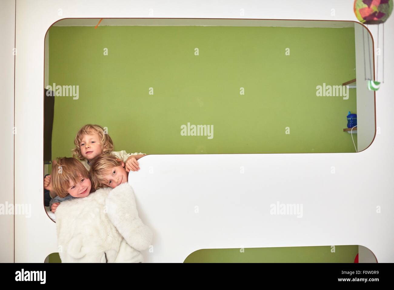 Three boys together on the top bunk of bunk beds, head and shoulders Stock Photo Alamy