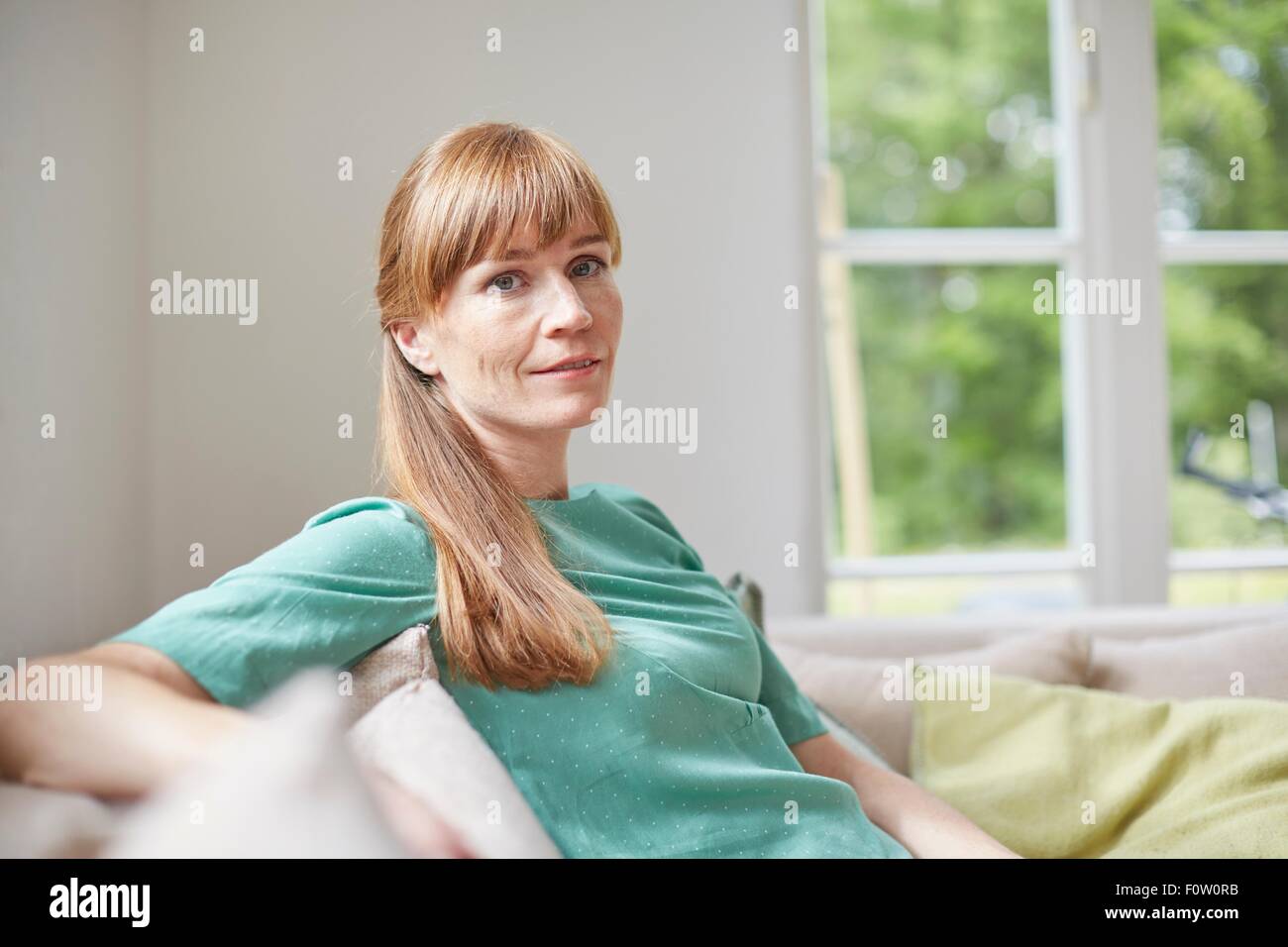 Portrait of red haired mid adult woman looking at camera Stock Photo