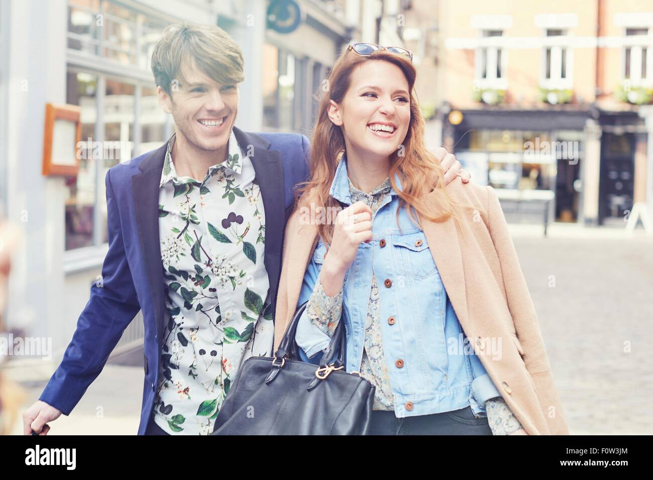 Stylish couple strolling on street, London, UK Stock Photo