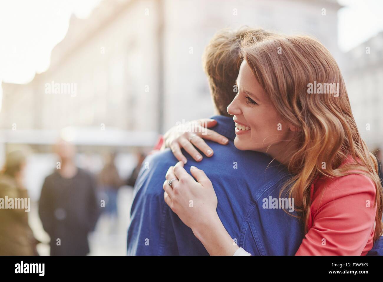 Couple hugging on street, London, UK Stock Photo