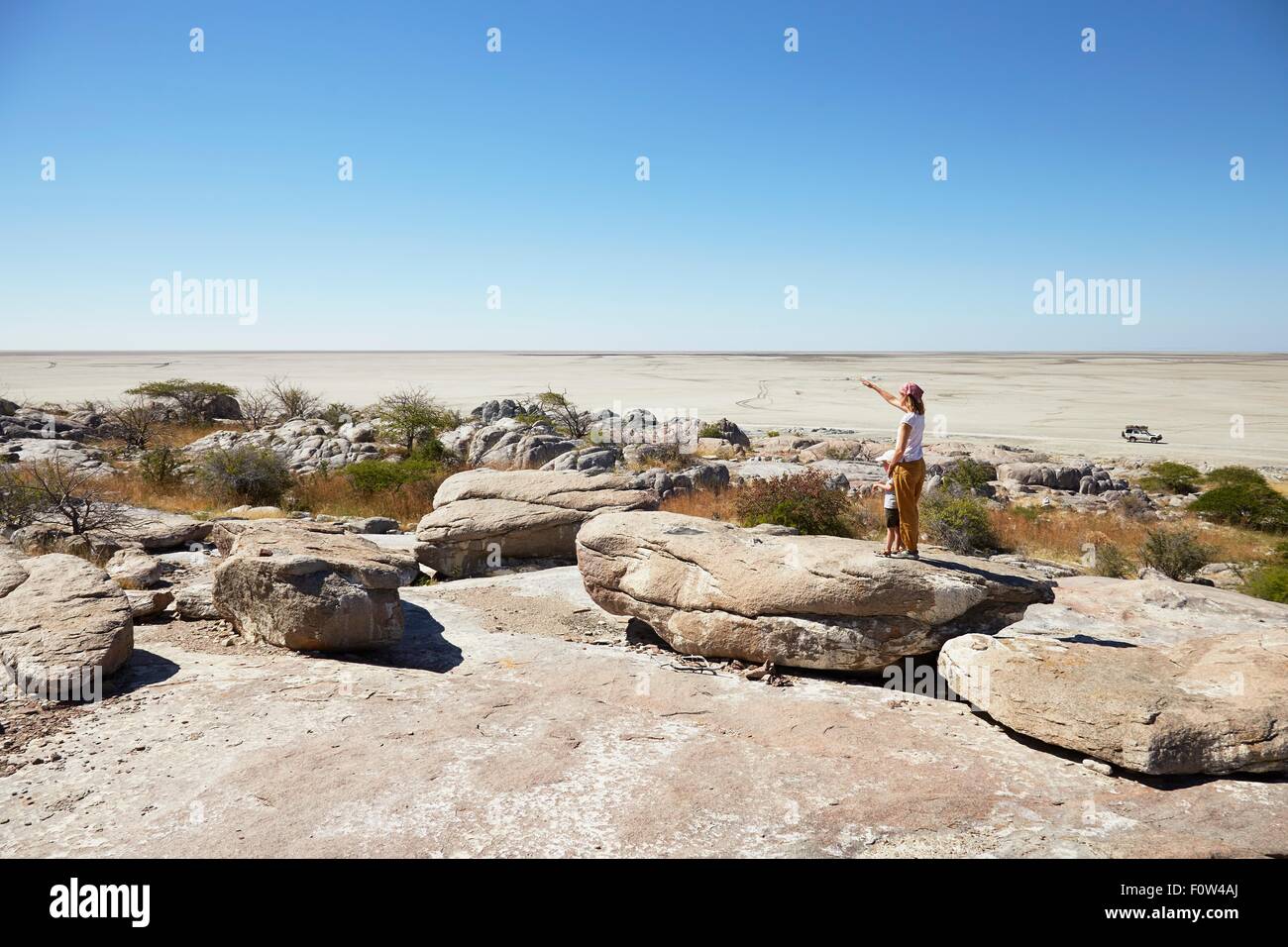 Mother and son on rock, Kubu Island, Makgadikgadi Pan, Botswana, Africa Stock Photo