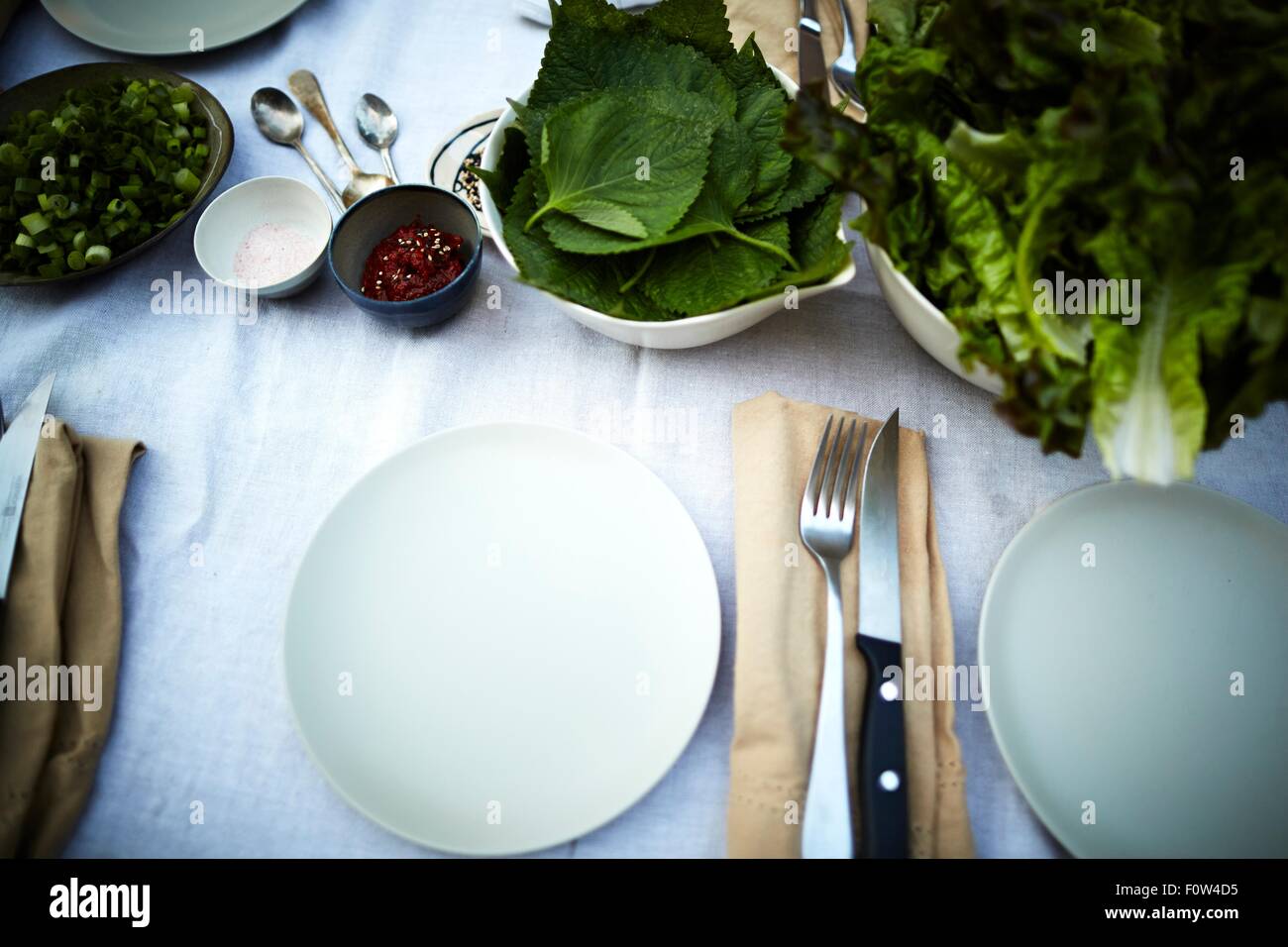 Table settings and fresh vegetable on table Stock Photo Alamy