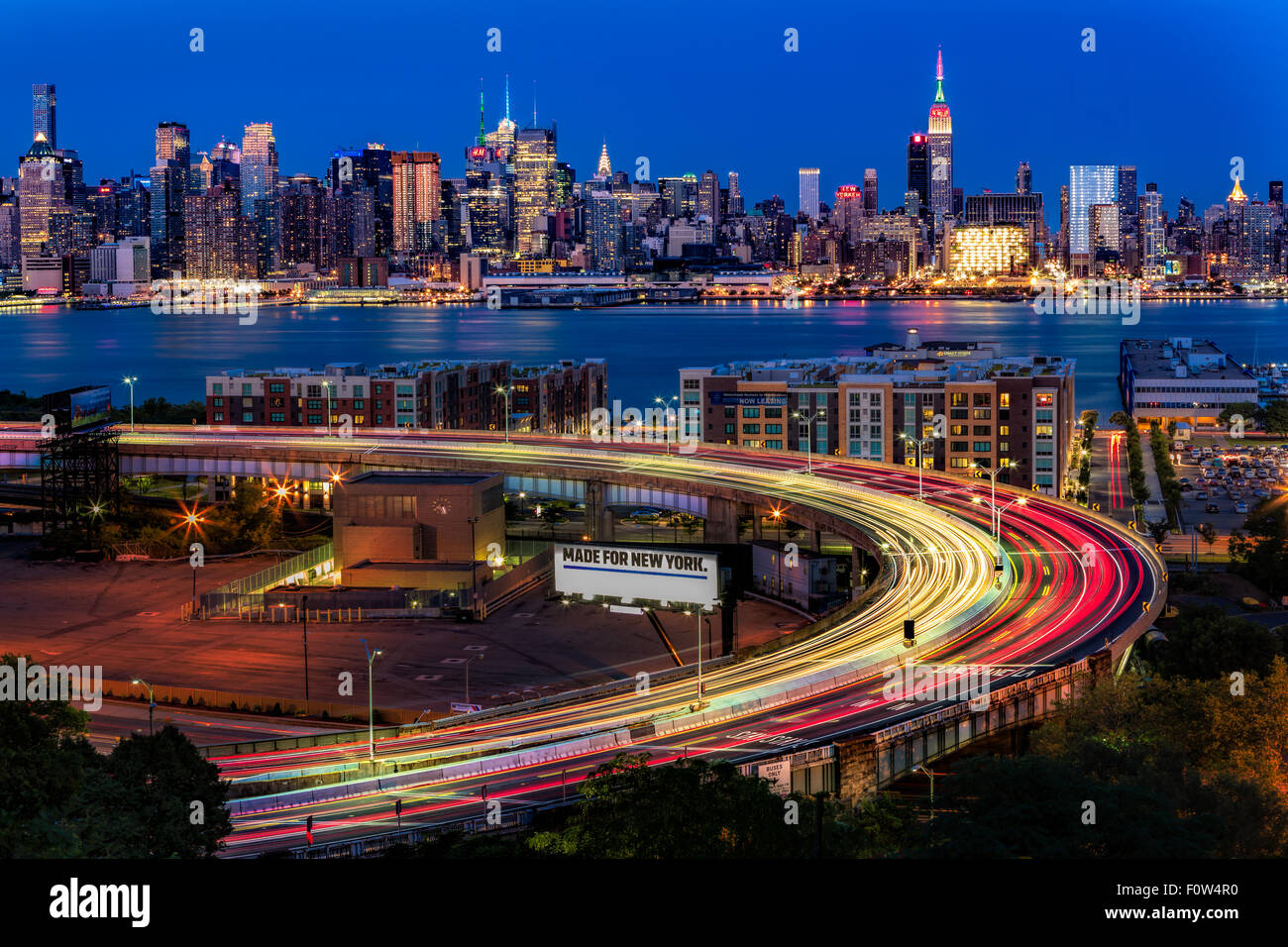 Upper view to the Lincoln Tunnel Helix, located in Weehawken, New Jersey and the Midtown Manhattan New York City Skyline during the blue hour of twilight. Stock Photo