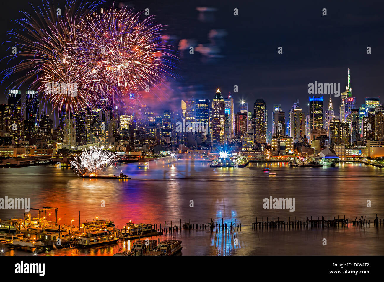 Manhattan NYC Summer Fireworks - Fireworks Summer display celebration on the Hudson River by midtown Manhattan with illuminated skyscrapers in New York City (NYC), New York. Stock Photo