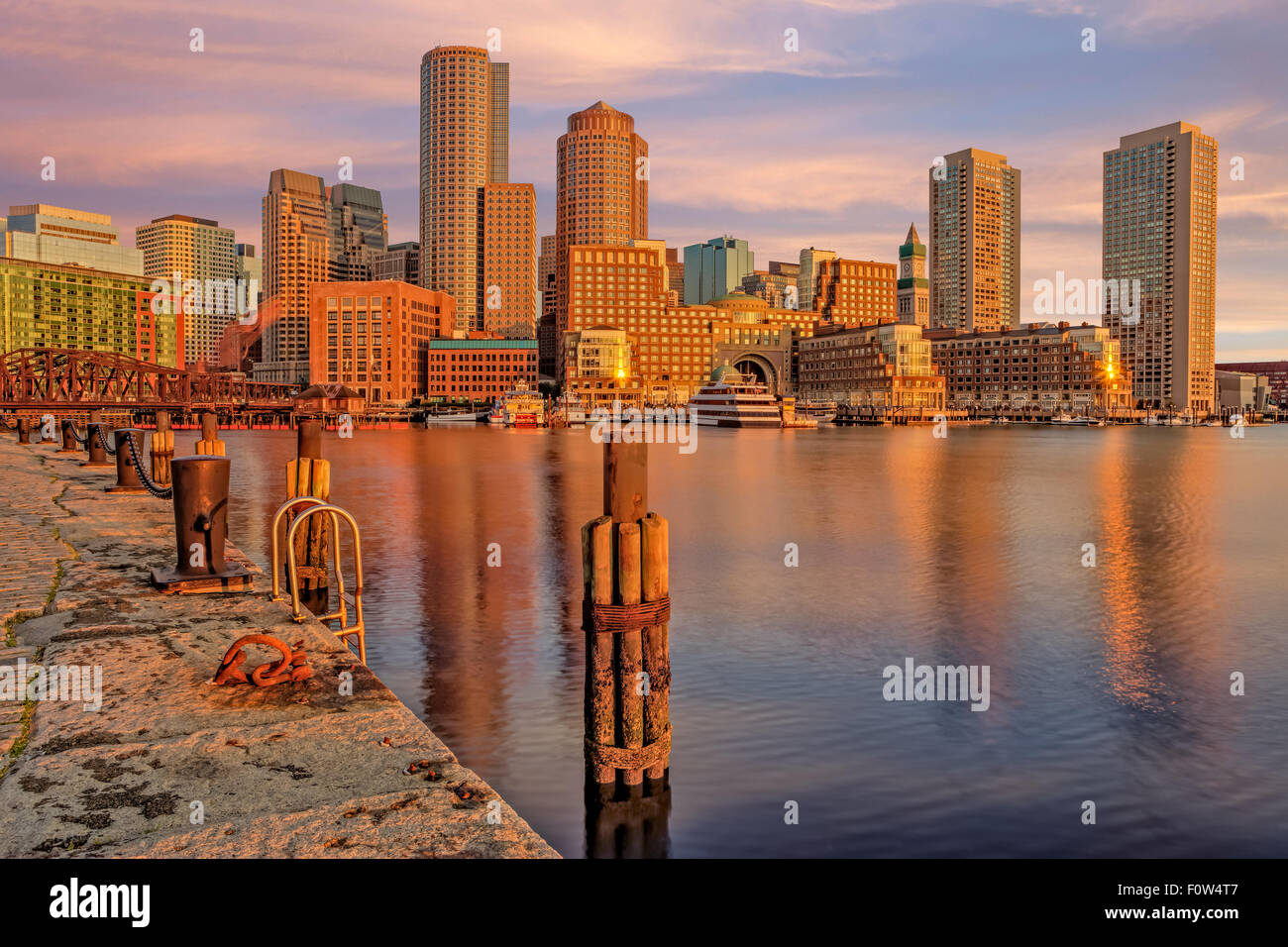 Boston Habor Sunrise - A view during sunrise to the Boston Harbor with the Boston Financial District's dramatic skyline.  Seen is Rowes Wharf, the Odyssey Cruise Yacht, along with other high rises along the waterfront. Stock Photo
