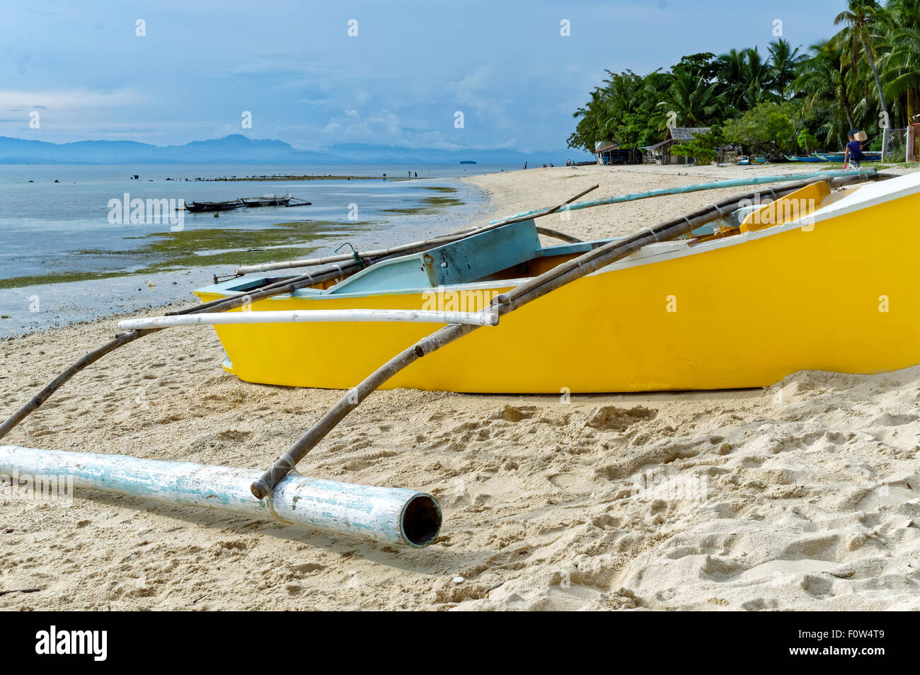 Boats At the Shore During A Low Tide. Local beach goers and tourists