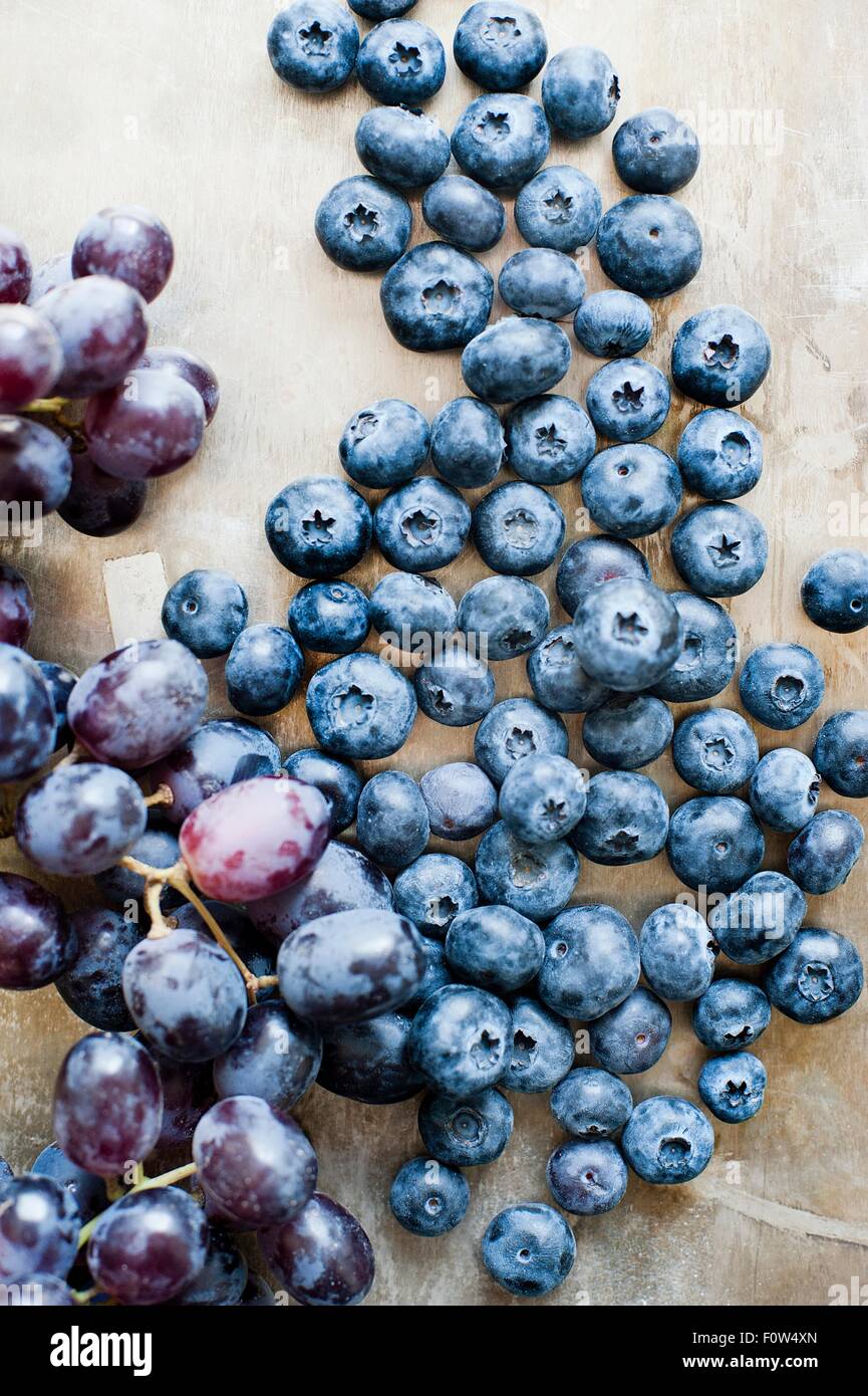 Blueberries and a bunch of black grapes Stock Photo