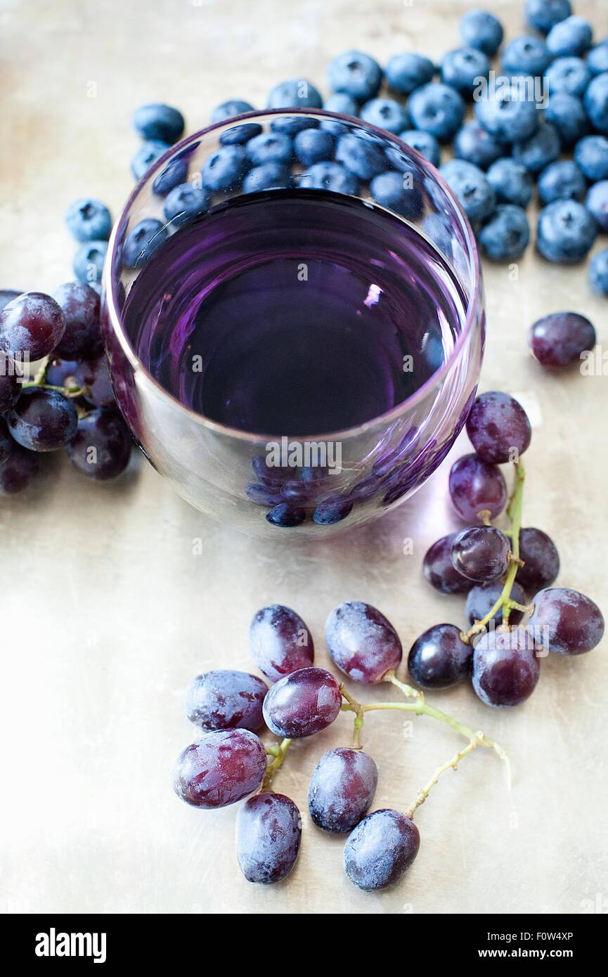 Glass of fruit juice made from blueberries and black grapes Stock Photo