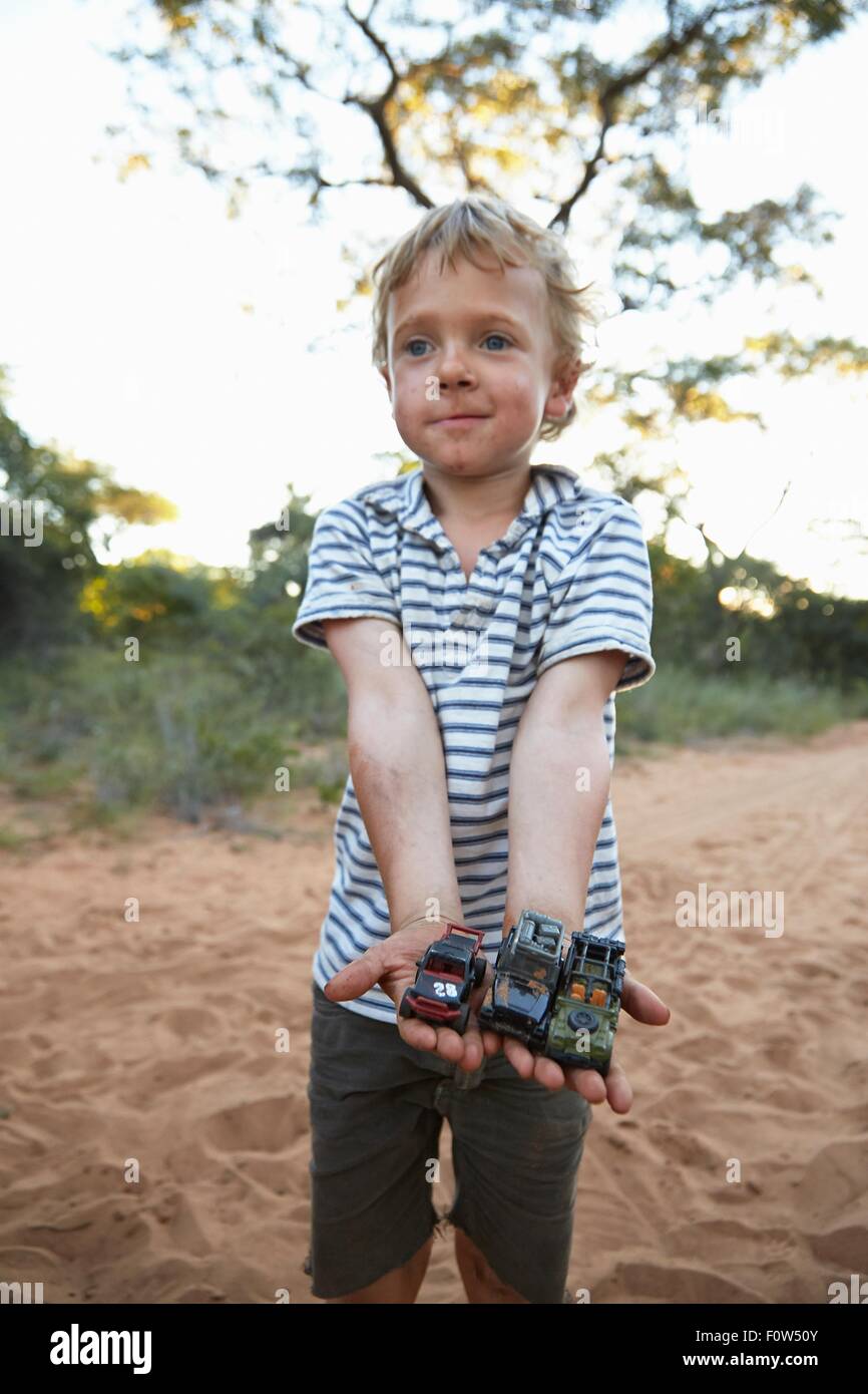 Portrait of young boy holding toy cars, Grootfontein, Kavango, Namibia Stock Photo