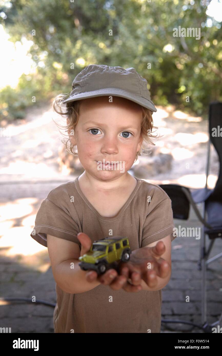 Portrait of young boy holding toy car Stock Photo