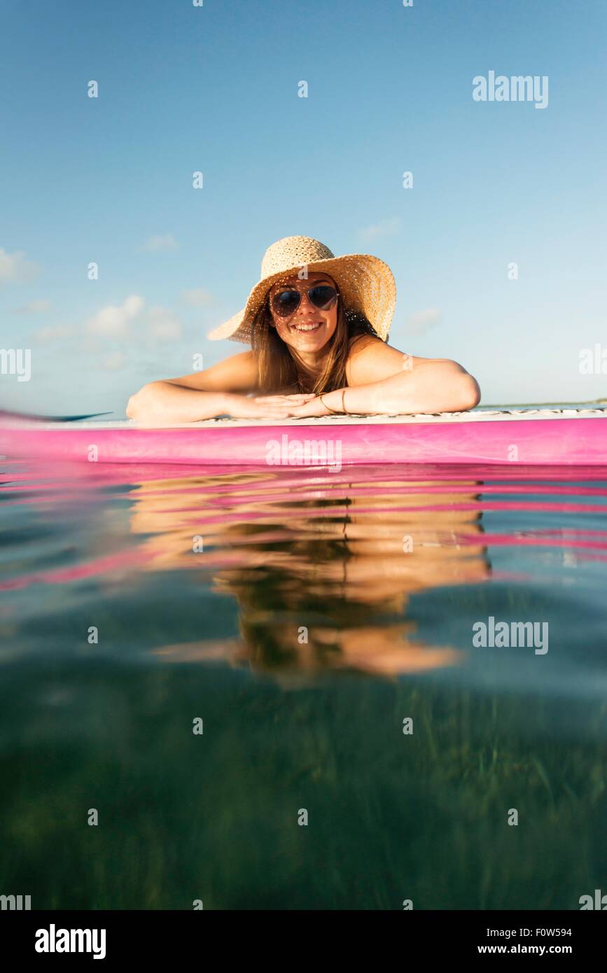 Surface level portrait of young woman and paddleboard, Islamorada, Florida, USA Stock Photo