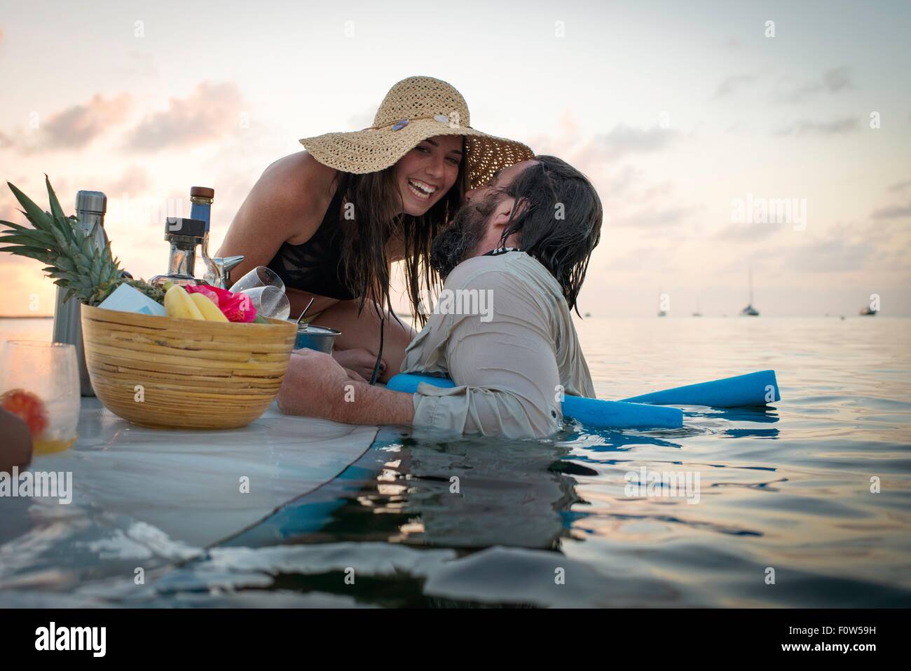 Romantic couple preparing cocktails on paddleboard, Islamorada, Florida, USA Stock Photo