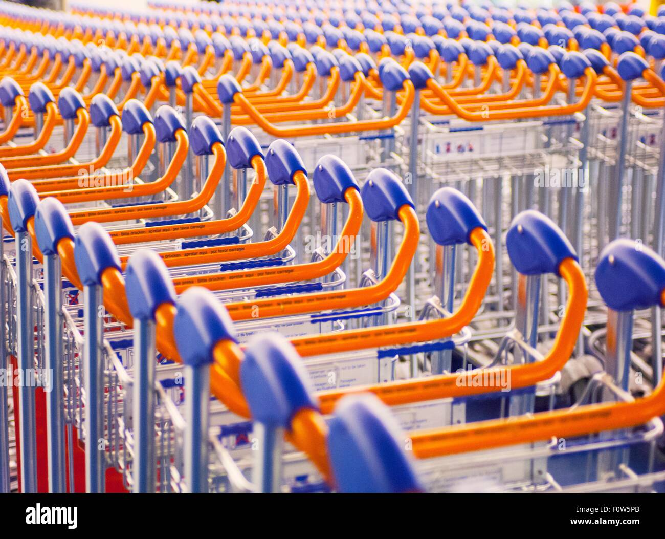 Rows of airport luggage trollies Stock Photo