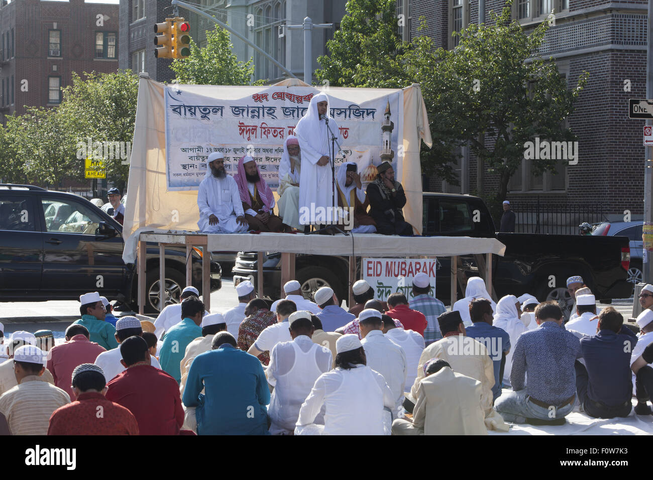Imam leads Muslims in prayer outside a mosque in Kensington, Brooklyn, NY for 'Eid al-Fitr.' The holiday,celebrated around the w Stock Photo