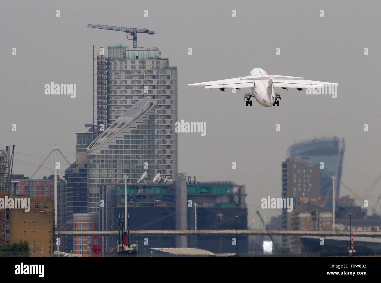 A CityJet Avro RJ85 registration EI-WXA takes off at London City Airport LCY. Stock Photo