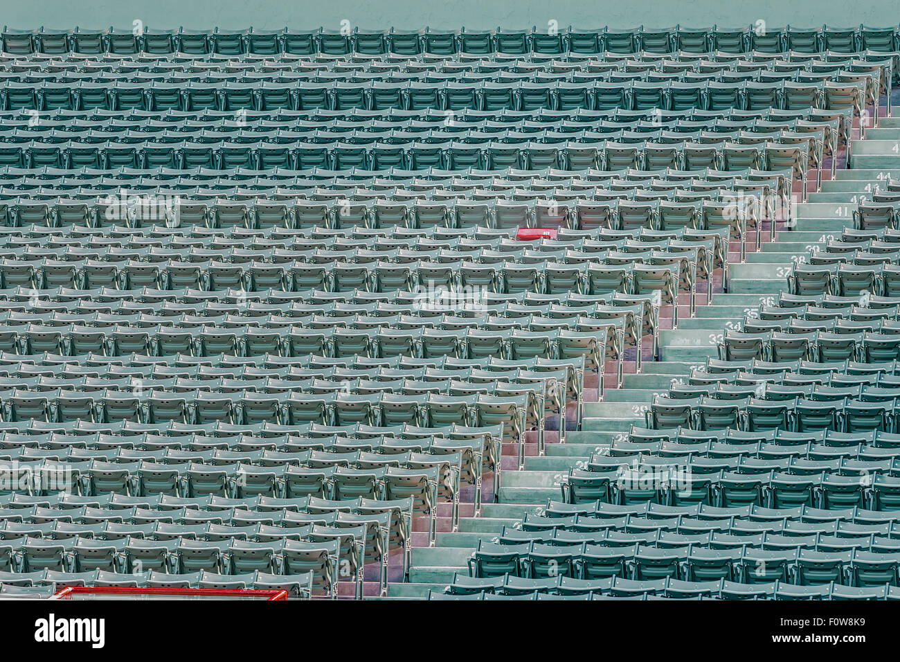 Fenway Park Red Chair Number 21 - The lone red seat in the right field bleachers (Section 42, Row 37, Seat 21) signifies the longest home run ever hit at Fenway. The home run, hit by Ted Williams on June 9, 1946, was officially measured at 502 feet. Stock Photo