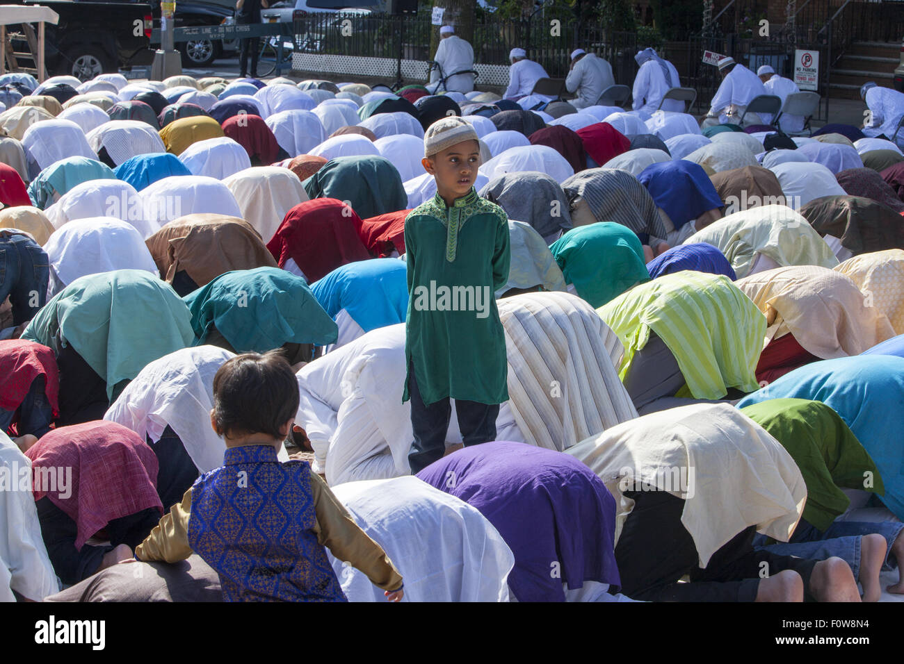 Muslims pray outside a mosque in Kensington, Brooklyn, NY for 'Eid al-Fitr.' The holiday celebrated around the world, marks the Stock Photo