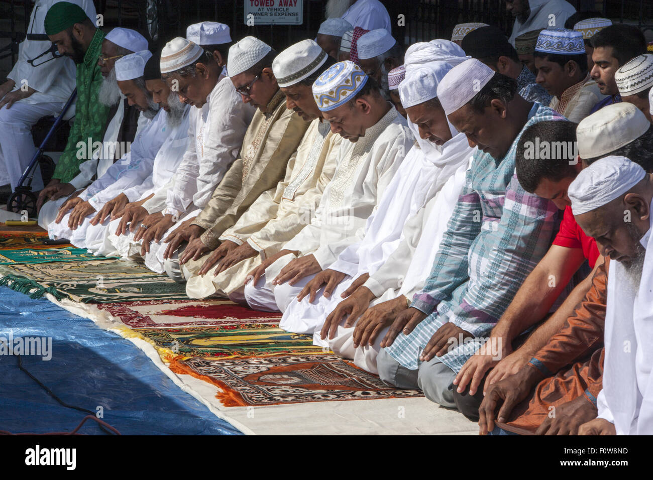 Muslims pray outside a mosque in Kensington, Brooklyn, NY for 'Eid al-Fitr.' The holiday is celebrated around the world, marking  the end of Ramadan. Stock Photo