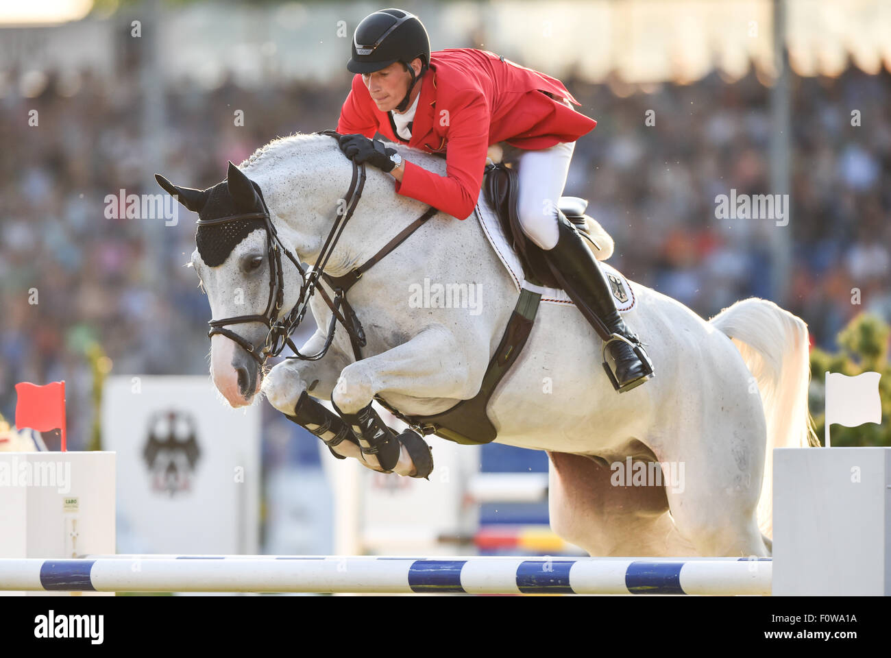 Aachen, Germany. 21st Aug, 2015. Daniel Deusser of Germany jumps with his horse Cornet d'Amour over an obstacle in the third round of the Show Jumping Team Final Competition during the FEI European Championships in Aachen, Germany, 21 August 2015. Photo: Uwe Anspach/dpa/Alamy Live News Stock Photo