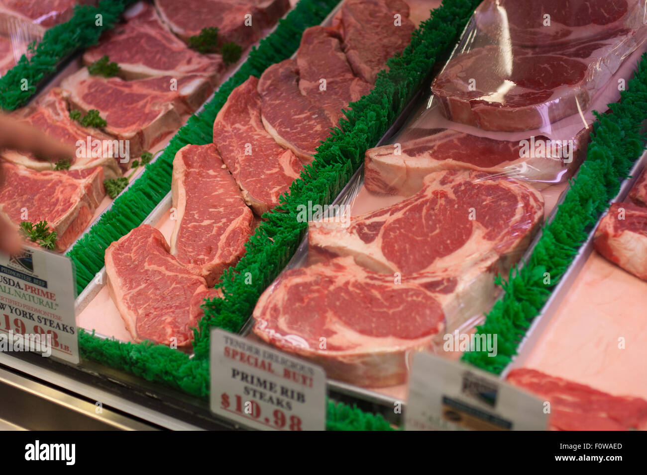 Steak in glass display case Stock Photo Alamy