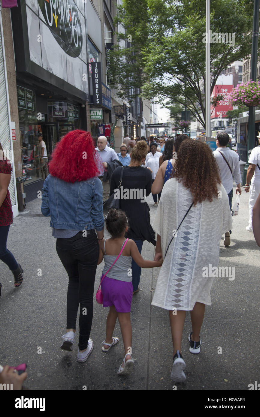 Artificial colors in the hair seems to be popular lately. 34th St. Manhattan, NYC. Stock Photo