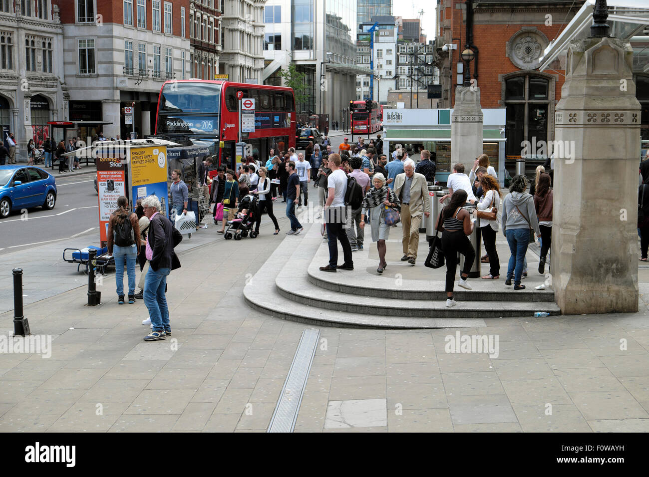 People in the street outside the entrance to  Liverpool Street Station in Bishopsgate London, UK   KATHY DEWITT Stock Photo