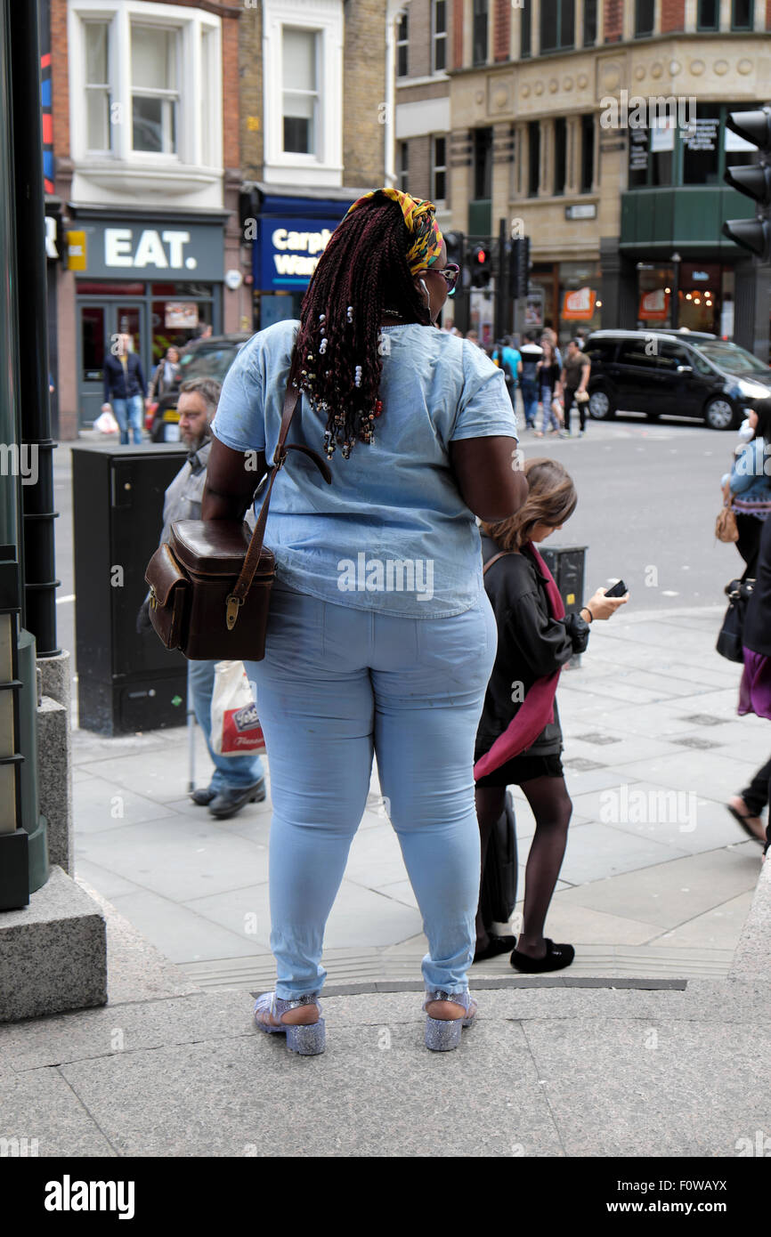 Rear view of attractive overweight black woman in tight denim jeans on a  city street in London, UK KATHY DEWITT Stock Photo - Alamy