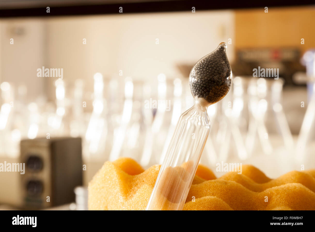 The base of a glass Hydrometer, that contains mercury beads or lead