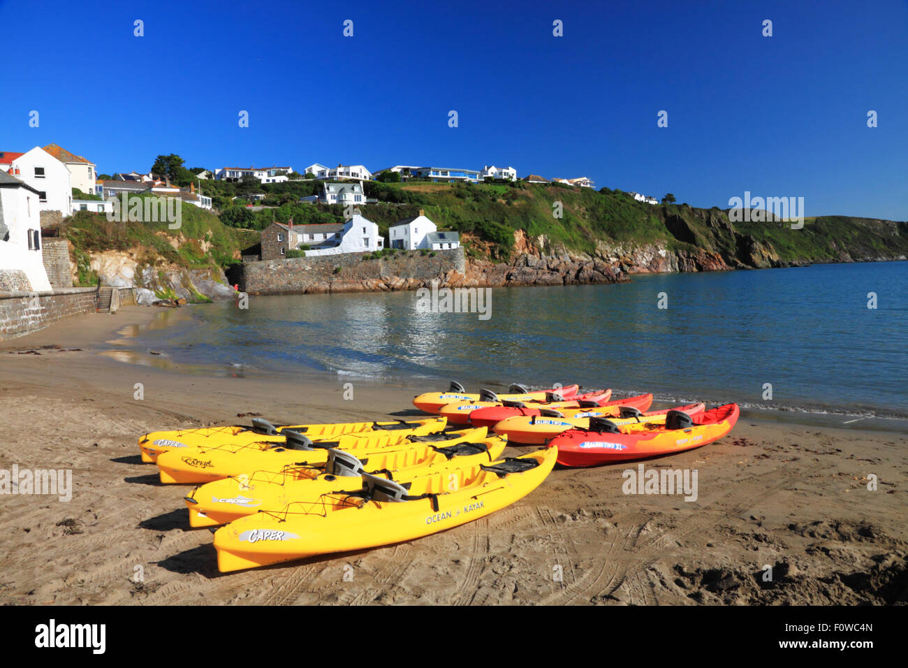 Yellow and red kayaks on a sandy Cornish beach Stock Photo - Alamy