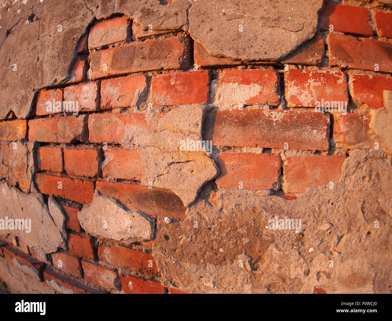 Fragment of an old shabby brick wall with wide angle fisheye lens view Stock Photo