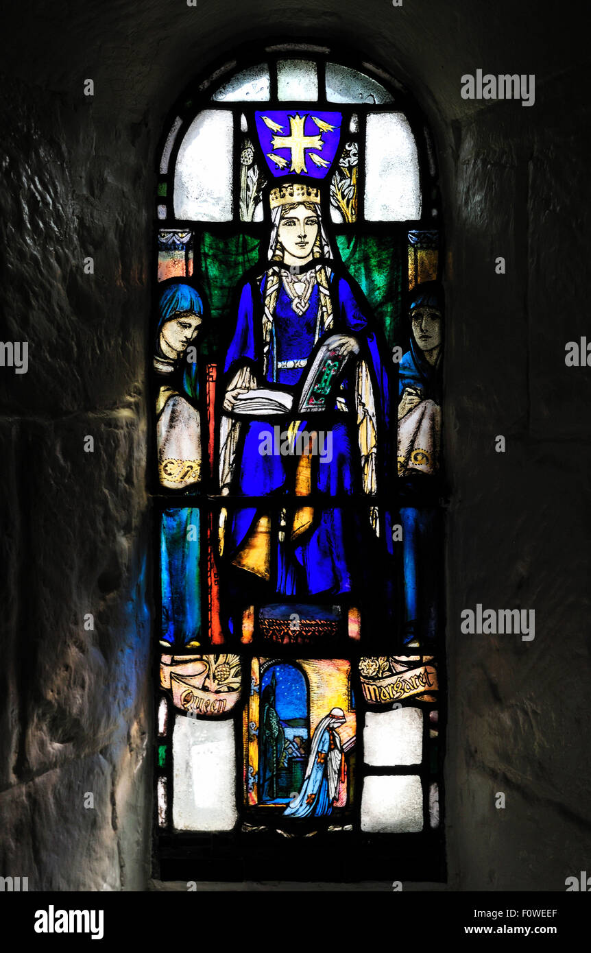 Stained glass window dating from 1922 in Saint Margaret's chapel, in Edinburgh Castle. The window honors Saint Margaret. Stock Photo