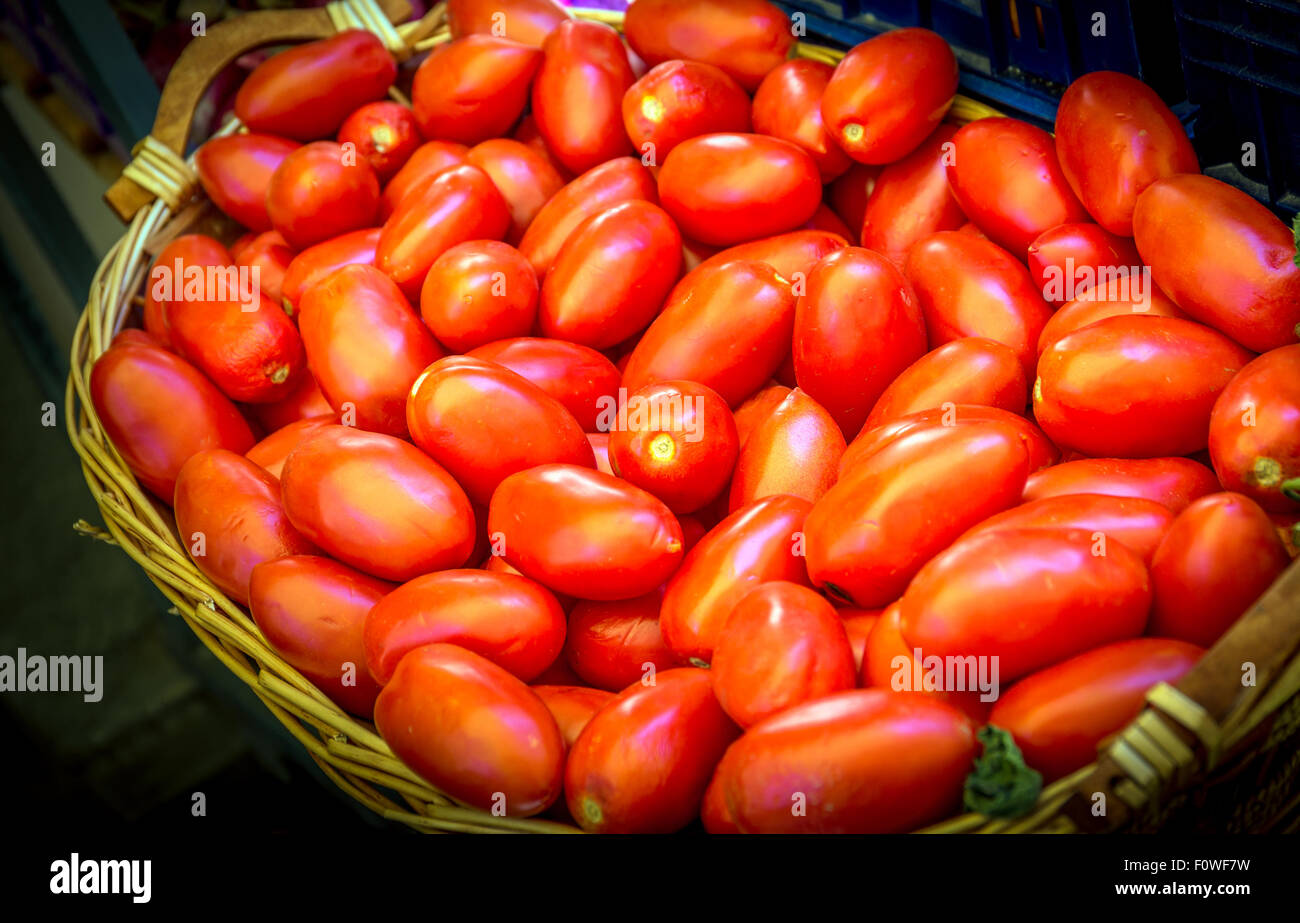 Red ripe tomatoes in a rustic wicker basket Stock Photo - Alamy