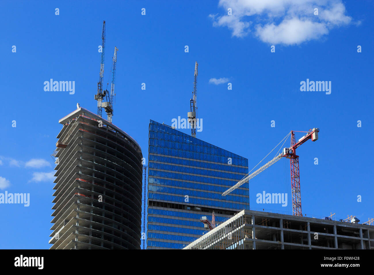 Several cranes working on a large construction site. Stock Photo