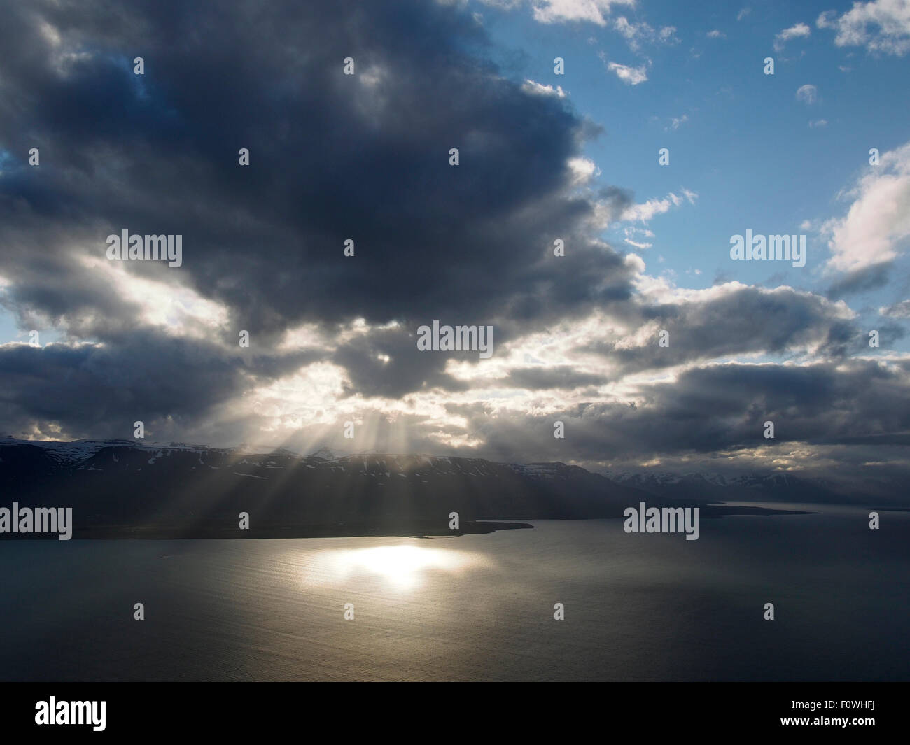 shafts of light breaking through clouds over Eyjafjörður from Ystuvíkurfjall, near Akureyri Iceland Stock Photo