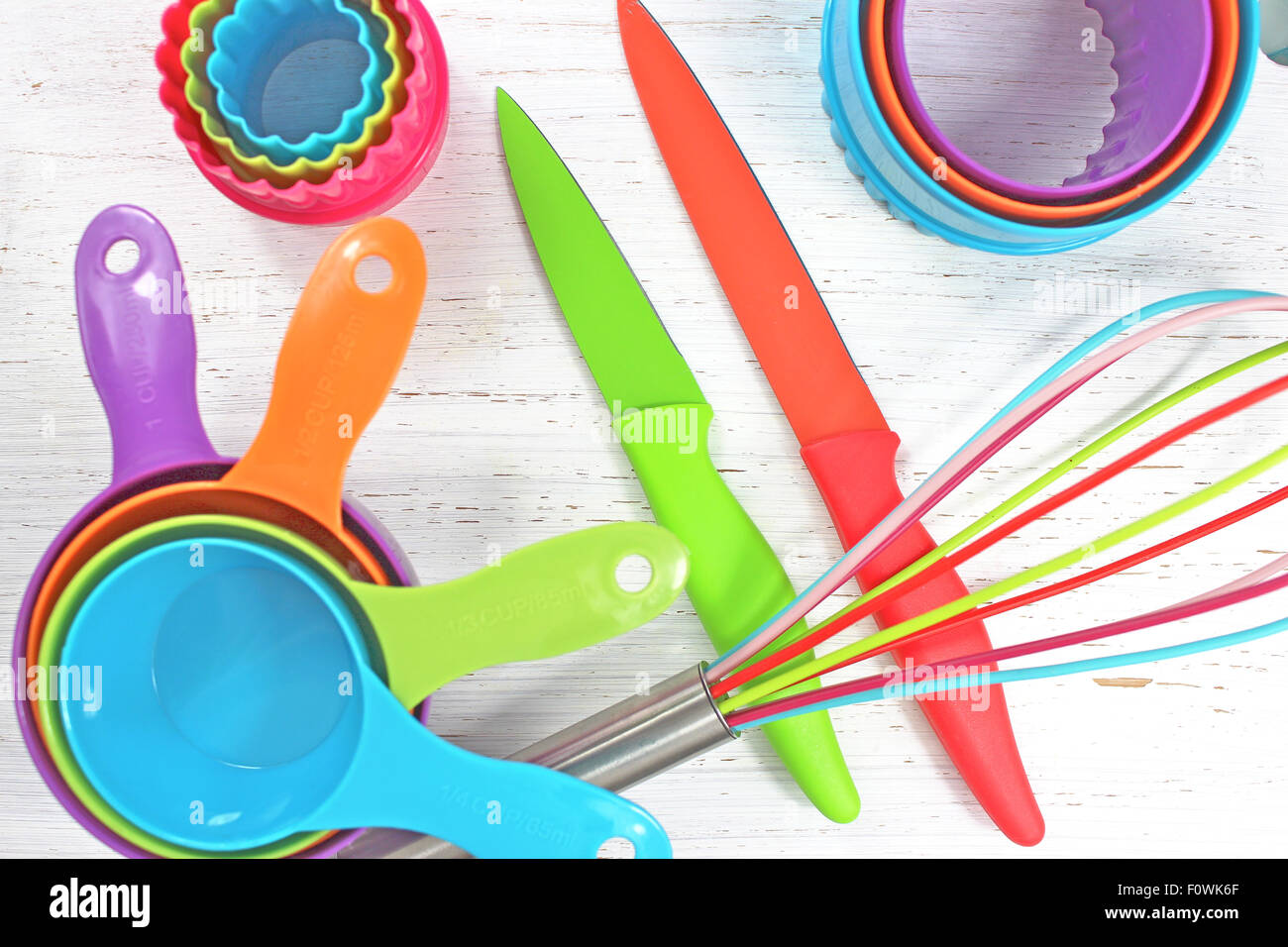 colorful kitchen utensils on white rustic background Stock Photo