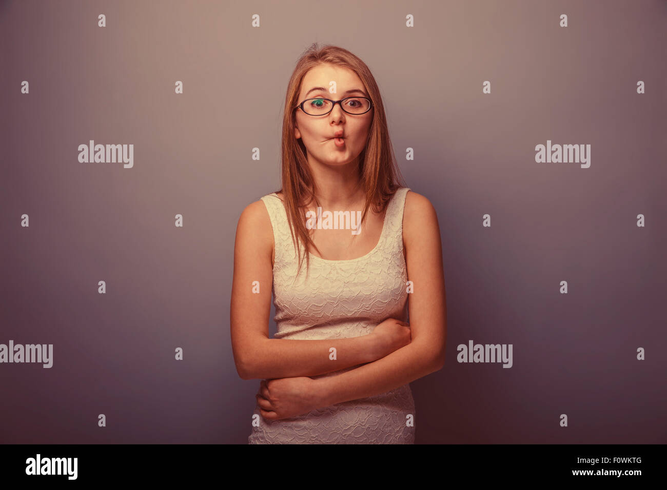 European appearance blonde girl pursed his lips forward on a gra Stock