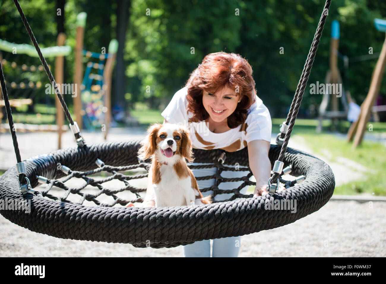 Mature woman swinging in park hi-res stock photography and images - Alamy