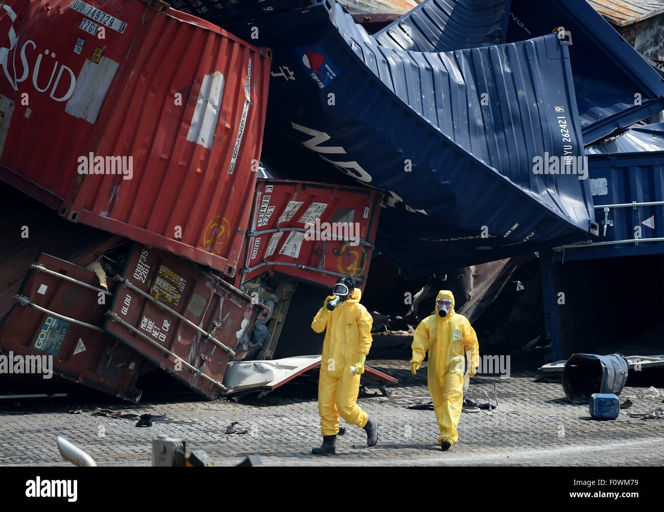 Tianjin, China. 22nd Aug, 2015. Rescuers clean up the debris at the core blast site in Tianjin, north China, Aug. 22, 2015. Chemical-hazard experts have sped up the cleanup operation at the core area of the Tianjin warehouse blasts. Credit:  Zhang Chenlin/Xinhua/Alamy Live News Stock Photo