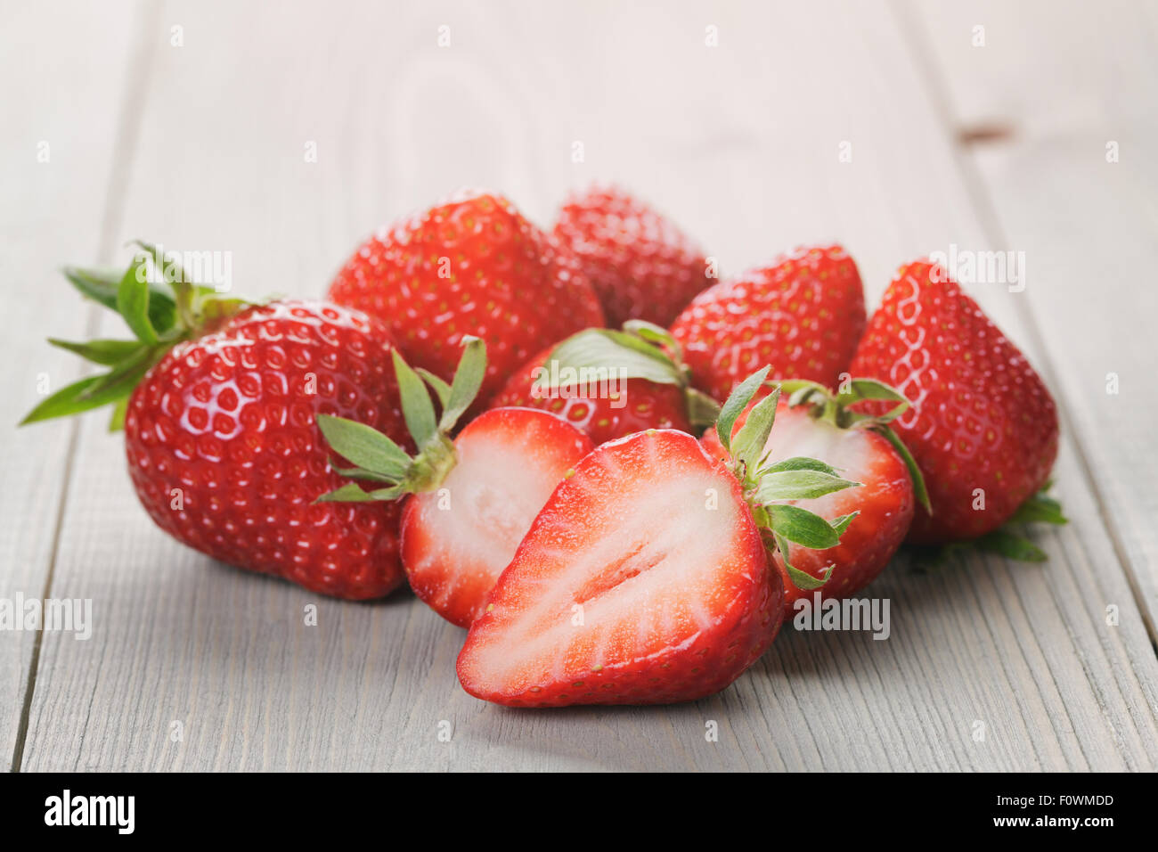 ripe strawberries on an old wooden table Stock Photo - Alamy