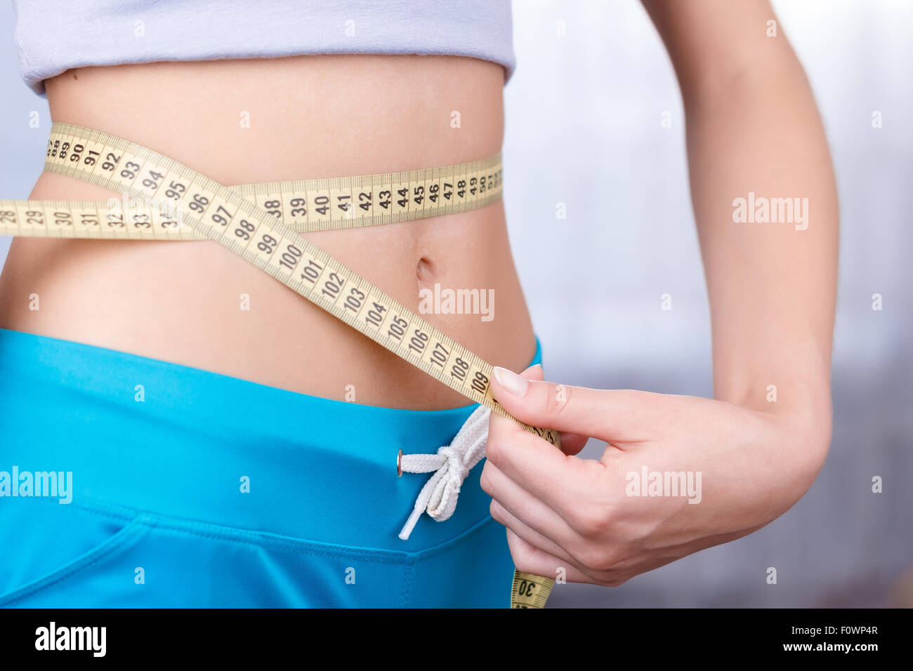 Woman measuring waist line Stock Photo - Alamy