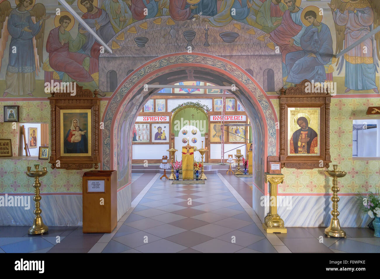 Archway to iconostasis and altar through halls of worship in church. Stock Photo