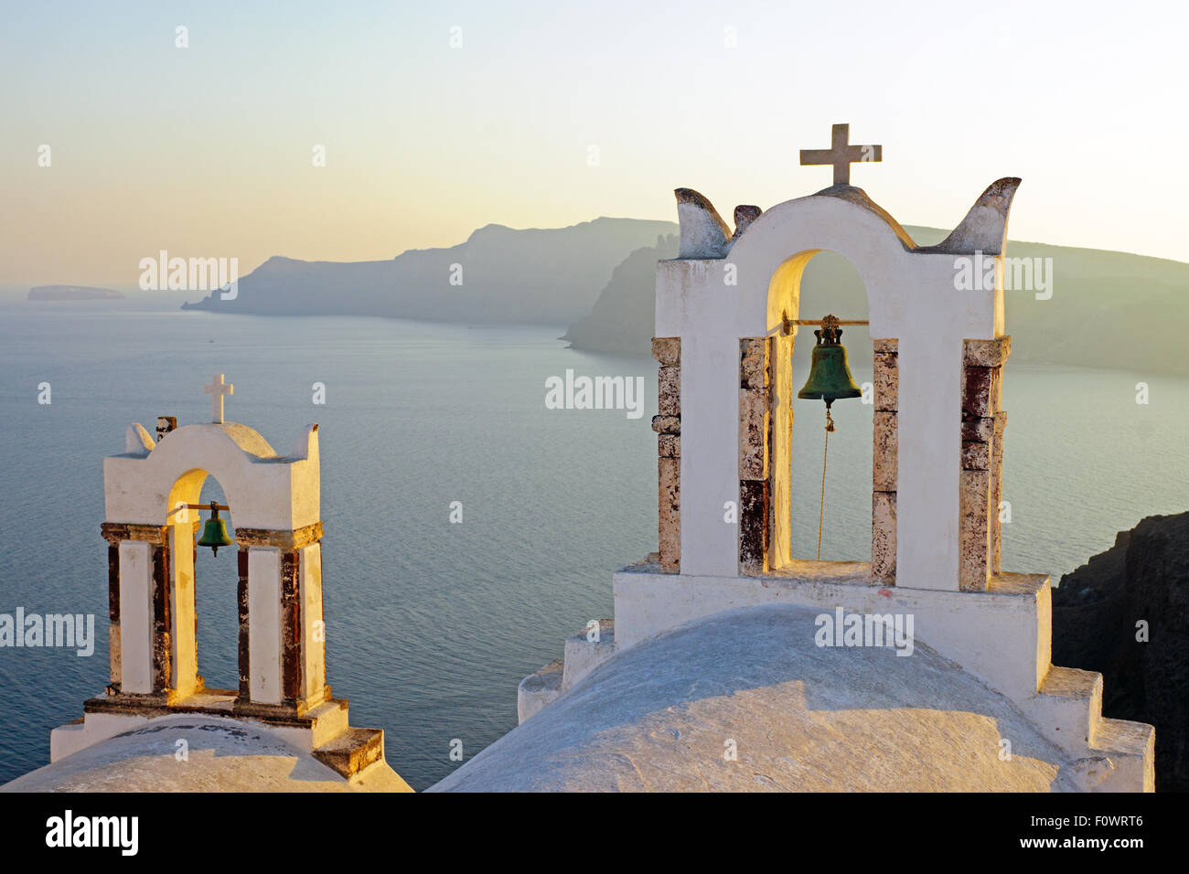 Two belltowers at sunset in Oia, Santorini Stock Photo