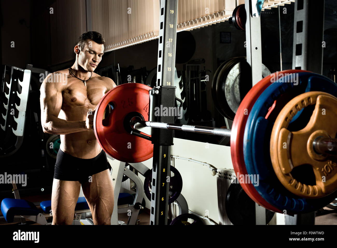 very power athletic guy ,  execute exercise with  weight Stock Photo