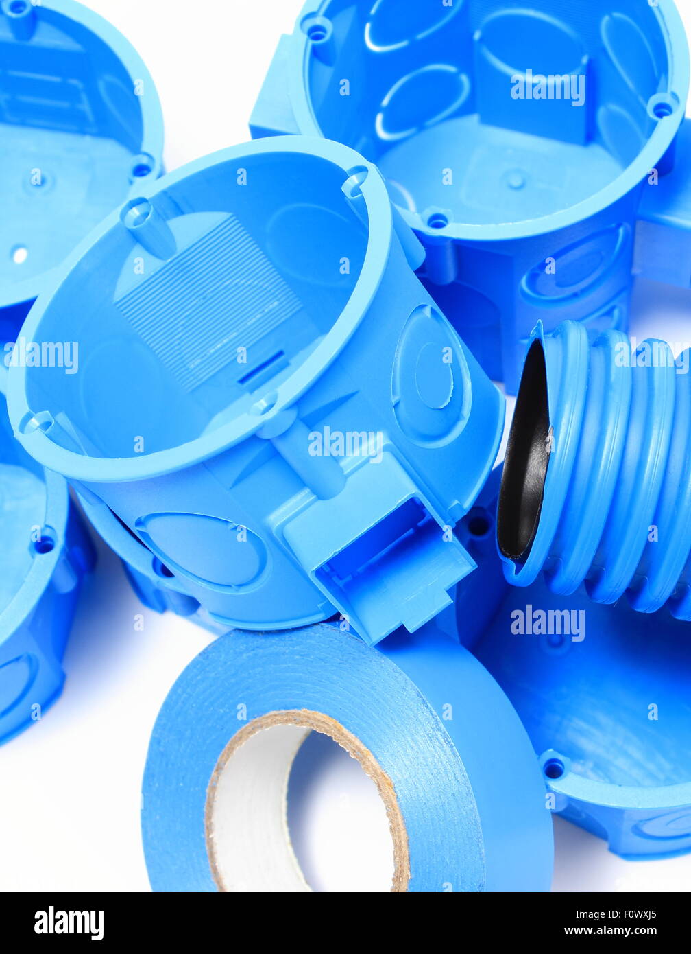 Heap of blue electrical boxes and components for use in electrical