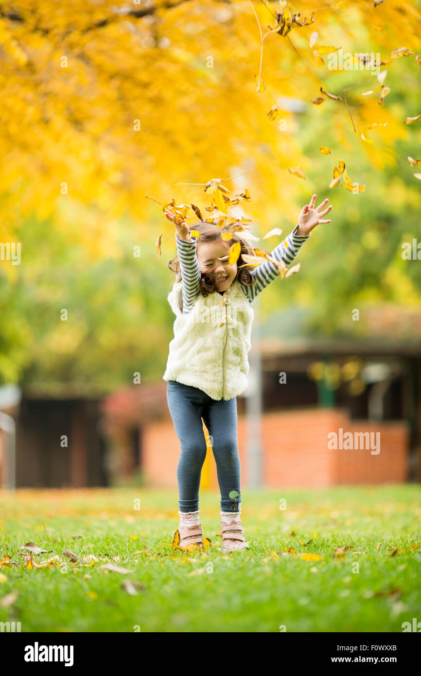 Little girl at the autumn park Stock Photo - Alamy