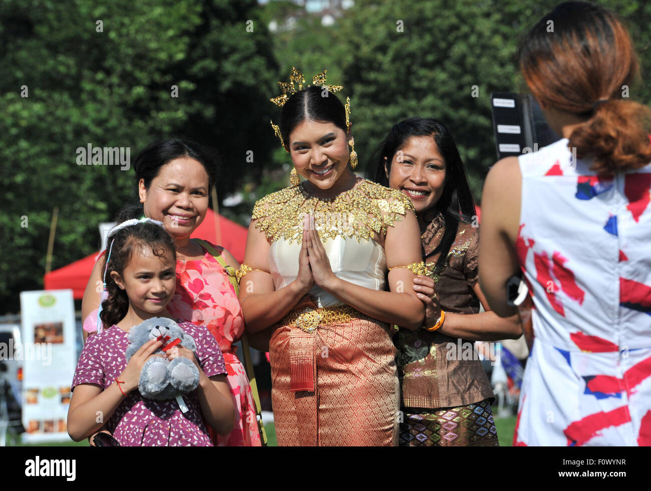 Brighton, UK. 22nd August, 2015. Visitors enjoy the blazing hot weather at the Brighton Thai Festival being held in Preston Park this weekend  Credit:  Simon Dack/Alamy Live News Stock Photo